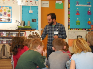 Volunteers Travis and Beleigh read to Ms.Moos 1st grade class